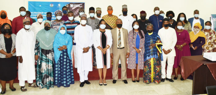 Permanent Secretary, Federal Ministry of Labour and Employment, Dr Yerima Peter Tarfa PhD (5th left) with the participants of the Validation of the National Policy on Child Forced Labour and the National Action Plan on the Elimination of Child Force Labour 2021 – 2025, in Abuja
